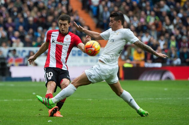 Athletic Bilbao's midfielder Oscar De Marcos (L) vies with Real Madrid's Colombian midfielder James Rodriguez during the Spanish league football match Real Madrid CF vs Athletic Club Bilbao at the Santiago Bernabeu stadium in Madrid on February 13, 2016. / AFP / CURTO DE LA TORRE        (Photo credit should read CURTO DE LA TORRE/AFP/Getty Images)