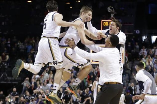 Notre Dame's Rex Pflueger, center, and Matt Farrell, left, celebrate with teammates after a second-round men's college basketball game in the NCAA Tournament, Sunday, March 20, 2016, in New York. Notre Dame won 76-75. (AP Photo/Frank Franklin II)