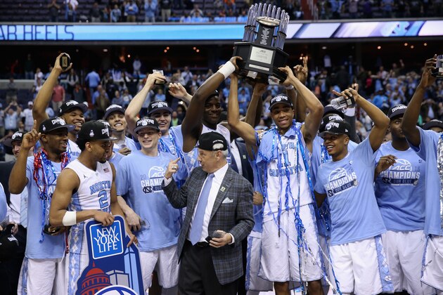 WASHINGTON, DC - MARCH 12:  The North Carolina Tar Heels hold up the conference trophy after defeating the Virginia Cavaliers 61-57 to win the 2016 ACC Basketball Tournament at Verizon Center on March 12, 2016 in Washington, DC.  (Photo by Rob Carr/Getty Images)