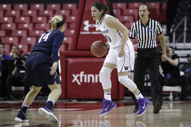 Washington guard Kelsey Plum, center, drives against Penn guard Beth Brzozowski in the first half of an NCAA college basketball game in the first round of the NCAA tournament, Saturday, March 19, 2016, in College Park, Md. (AP Photo/Patrick Semansky)