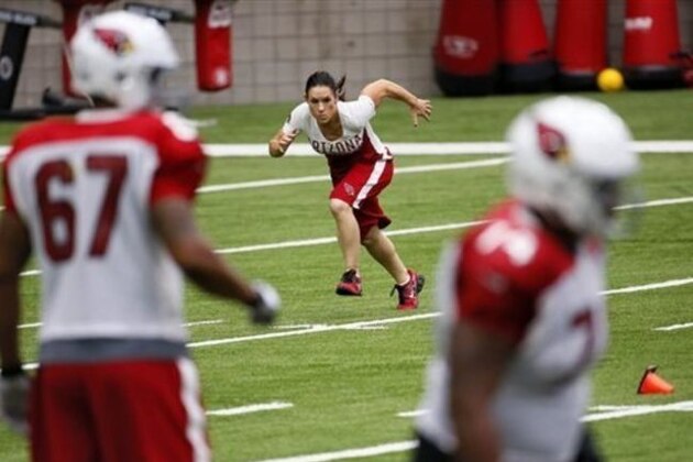 FILE - In this Aug. 24, 2015, file photo, Arizona Cardinals training camp coach Jen Welter runs during an NFL football camp in Glendale, Ariz. Praising the coaches and players for accepting her without reservation, Jen Welker is proud she's opened another door for women in men's professional sports as the first female coach of any kind on an NFL team.(AP Photo/Matt York, File)