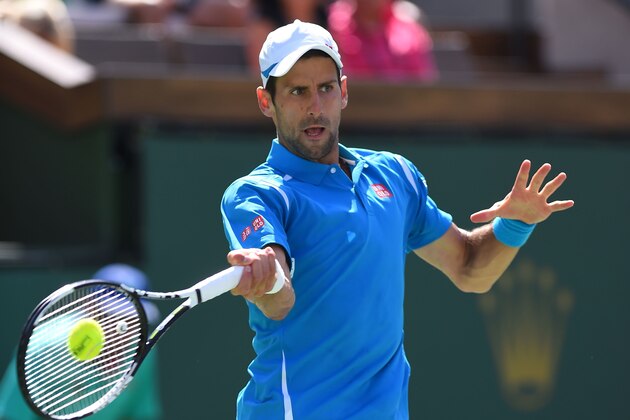 Novak Djokovic of Serbia returns the ball to Milos Raonic of Canada in the men's final of the BNP Paribas Open at the Indian Wells Tennis Garden in Indian Wells, California, March 20, 2016. Djokovic defeated Raonic 6-2, 6-0. / AFP / ROBYN BECK        (Photo credit should read ROBYN BECK/AFP/Getty Images)