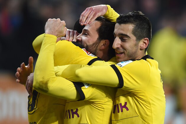 (L-R) Dortmund's Columbian striker Adrian Ramos, Dortmund's midfielder Gonzalo Castro and Dortmund's Armenian midfielder Henrikh Mkhitaryan celebrate after scoring the second goal for Dortmund during the German Bundesliga first division football match between FC Augsburg vs Borussia Dortmund in Augsburg, southern Germany, on March 20, 2016.
Dortund won the match 1-3. / AFP / CHRISTOF STACHE / RESTRICTIONS: DURING MATCH TIME: DFL RULES TO LIMIT THE ONLINE USAGE TO 15 PICTURES PER MATCH AND FORBID IMAGE SEQUENCES TO SIMULATE VIDEO. == RESTRICTED TO EDITORIAL USE == FOR FURTHER QUERIES PLEASE CONTACT DFL DIRECTLY AT + 49 69 650050
        (Photo credit should read CHRISTOF STACHE/AFP/Getty Images)