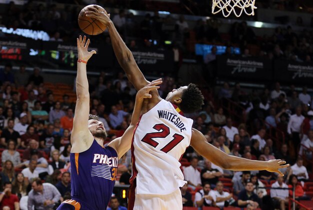 Mar 3, 2016; Miami, FL, USA; Miami Heat center Hassan Whiteside (21) blocks the shot from Phoenix Suns forward Mirza Teletovic (35) during the first half at American Airlines Arena. Mandatory Credit: Steve Mitchell-USA TODAY Sports