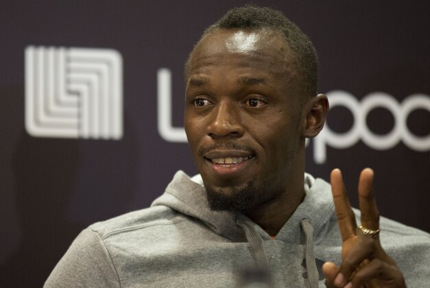 Jamaican sprinter Usain Bolt makes the victory sign as he answers questions during a promotional event for Puma at a department store, in Mexico City, Wednesday, Oct. 7, 2015. (AP Photo/Rebecca Blackwell)