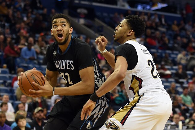 NEW ORLEANS, LA - JANUARY 19:  Karl-Anthony Towns #32 of the Minnesota Timberwolves works against Anthony Davis #23 of the New Orleans Pelicans during the second half of a game at the Smoothie King Center on January 19, 2016 in New Orleans, Louisiana. New Orleans defeated Minnesota 114-99. NOTE TO USER: User expressly acknowledges and agrees that, by downloading and or using this photograph, User is consenting to the terms and conditions of the Getty Images License Agreement.  (Photo by Stacy Revere/Getty Images)
