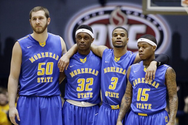 Morehead State players Billy Reader (50), Brent Arrington (32), Corban Collins (3) and Kareem Storey (15) watch as a Murray State player shoots a free throw after a Morehead State technical foul during the first half of an NCAA college basketball game in the semifinals of the Ohio Valley Conference tournament Friday, March 6, 2015, in Nashville, Tenn. (AP Photo/Mark Humphrey)