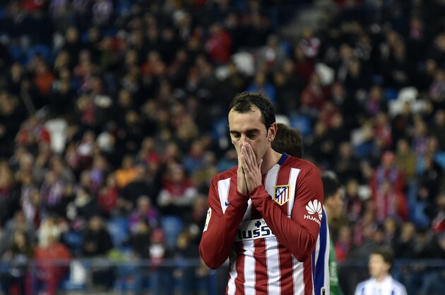 Atletico Madrid's Uruguayan defender Diego Godin gestures after missing a goal opportunity during the Spanish league football match Club Atletico de Madrid vs Real Sociedad de Futbol at the Vicente Calderon stadium in Madrid on March 1, 2016. / AFP / GERARD JULIEN        (Photo credit should read GERARD JULIEN/AFP/Getty Images)