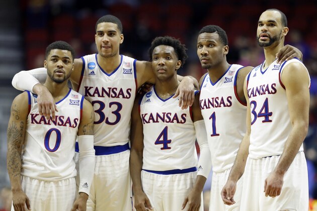 Kansas' Frank Mason III (0), Landen Lucas (33), Devonte' Graham (4), Wayne Selden Jr. (1) and Perry Ellis (34) gather during the second half of a second-round men's college basketball game against Connecticut in the NCAA Tournament, Saturday, March 19, 2016, in Des Moines, Iowa. Kansas won 73-61. (AP Photo/Charlie Neibergall)