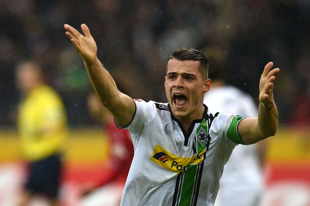 Moenchengladbach's Swiss midfielder Granit Xhaka reacts during the German first division Bundesliga football match Borussia Moenchengladbach vs 1. FC Cologne in Moenchengladbach , western Germany, on February  20, 2016. / AFP / PATRIK STOLLARZ / RESTRICTIONS: DURING MATCH TIME: DFL RULES TO LIMIT THE ONLINE USAGE TO 15 PICTURES PER MATCH AND FORBID IMAGE SEQUENCES TO SIMULATE VIDEO. == RESTRICTED TO EDITORIAL USE == FOR FURTHER QUERIES PLEASE CONTACT DFL DIRECTLY AT + 49 69 650050
        (Photo credit should read PATRIK STOLLARZ/AFP/Getty Images)