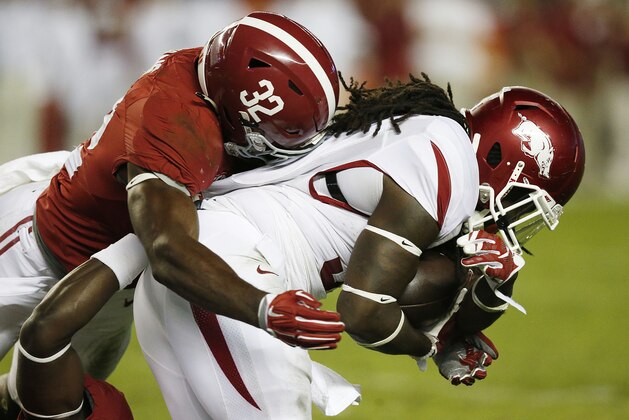 Alabama linebacker Rashaan Evans (32) tackles Arkansas running back Alex Collins (3)in the second half of an NCAA college football game, Saturday, Oct. 10, 2015, in Tuscaloosa, Ala. (AP Photo/Brynn Anderson)