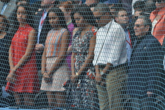 US President Barack Obama (2-R), First Lady Michelle Obama (C), their daughters Sasha and Malia (L) and Cuban President Raul Castro (R) hold a minute of silence for the terrorist attacks which took place in Belgium before a Major League baseball exhibition game at the Latinoamericano stadium in Havana on March 22, 2016. Obama praised the bravery of Cuban dissidents Tuesday in a meeting at the US embassy in Havana, although opponents back home dismissed the event as a 'token' gesture. AFP PHOTO / Rodrigo ARANGUA / AFP / RODRIGO ARANGUA        (Photo credit should read RODRIGO ARANGUA/AFP/Getty Images)
