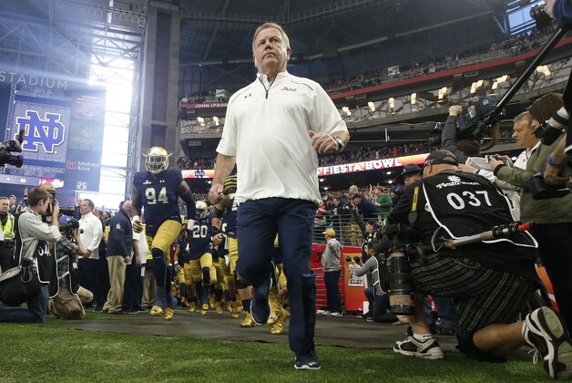 Notre Dame head coach Brian Kelly leads his players onto the field prior to the Fiesta Bowl NCAA College football game against Ohio State , Friday, Jan. 1, 2016, in Glendale, Ariz.  (AP Photo/Ross D. Franklin)