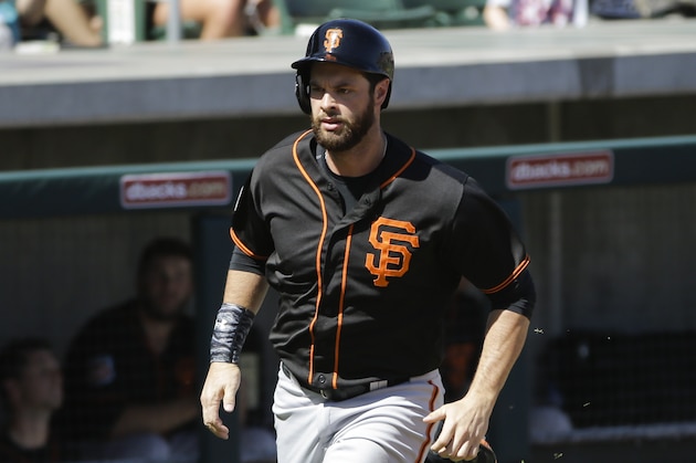 San Francisco Giants' Brandon Belt runs to home plate during a spring training baseball game against the Colorado Rockies Sunday, March 20, 2016, in Scottsdale, Ariz. (AP Photo/Jae C. Hong)