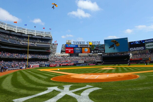 Jul 20, 2014; Bronx, NY, USA;   Members of the U.S. Army Golden Knights parachute team land inside Yankee Stadium before the game between the New York Yankees and the Cincinnati Reds. Mandatory Credit: Anthony Gruppuso-USA TODAY Sports