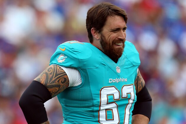 ORCHARD PARK, NY - SEPTEMBER 14:  Daryn Colledge #67 of the Miami Dolphins catches his breath in the first half against the Buffalo Bills at Ralph Wilson Stadium on September 14, 2014 in Orchard Park, New York.  (Photo by Vaughn Ridley/Getty Images)