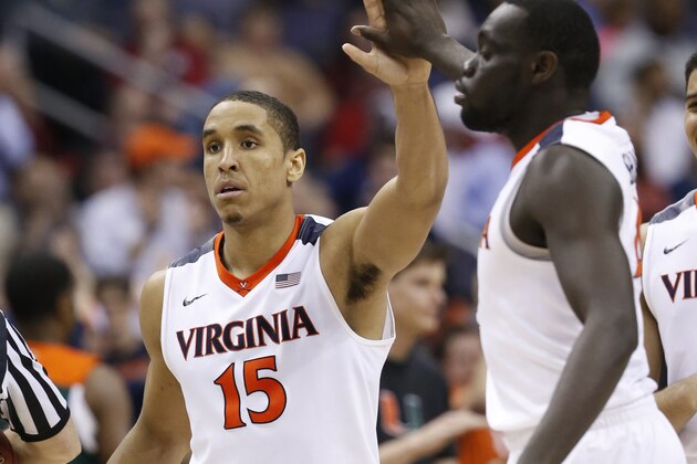 Virginia guard Malcolm Brogdon (15) gives a high-five to guard Marial Shayok (4) during the second half of an NCAA college basketball game against Miami in the Atlantic Coast Conference  men'stournament, Friday, March 11, 2016, in Washington. Virginia defeated Miami 73-68. (AP Photo/Steve Helber)