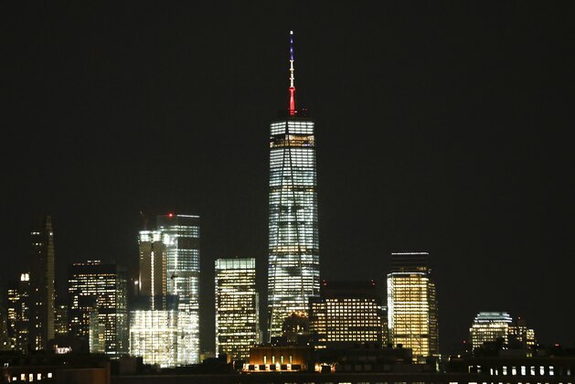 One World Trade Center is shown Tuesday, March 22, 2016, in New York. New York Gov. Andrew Cuomo has directed One World Trade Center be displayed in the Belgium colors of black, yellow and red to show solidarity with the nation following attacks that killed dozens of people in Brussels. (AP Photo/Frank Franklin II)