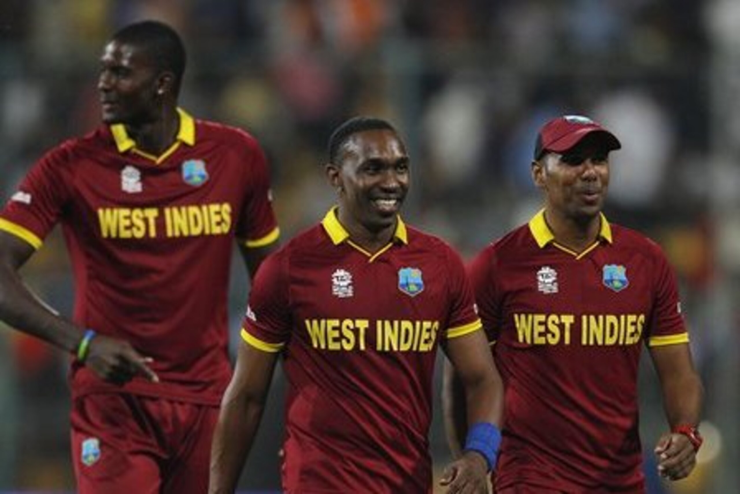West Indies’ Dwayne Bravo, center, leaves the field with teammates Samuel Badree, right, and Jason Holder at the end of the first innings during their ICC World Twenty20 2016 cricket match against Sri Lanka in Bangalore, India, Sunday, March 20, 2016. (AP Photo/Aijaz Rahi)