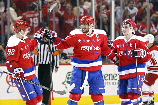 Mar 15, 2016; Washington, DC, USA; Washington Capitals left wing Alex Ovechkin (8) celebrates with Capitals center Evgeny Kuznetsov (92) and Capitals defenseman Dmitry Orlov (9) after scoring the game-winning goal in overtime against the Carolina Hurricanes at Verizon Center. The Capitals won 2-1. Mandatory Credit: Geoff Burke-USA TODAY Sports