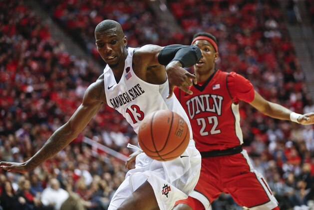 San Diego State forward Winston Shepard goes for the loose ball beating UNLV's Patrick McCaw to the possession during the first half of an NCAA college basketball game Saturday, March 5, 2016, in San Diego. (AP Photo/Lenny Ignelzi)