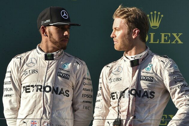 Mercedes AMG Petronas F1 Team's German driver Nico Rosberg (R) talks to his teammate British driver Lewis Hamilton on the podium during the Formula One Australian Grand Prix in Melbourne on March 20, 2016.  / AFP / SAEED KHAN / IMAGE RESTRICTED TO EDITORIAL USE - STRICTLY NO COMMERCIAL USE        (Photo credit should read SAEED KHAN/AFP/Getty Images)