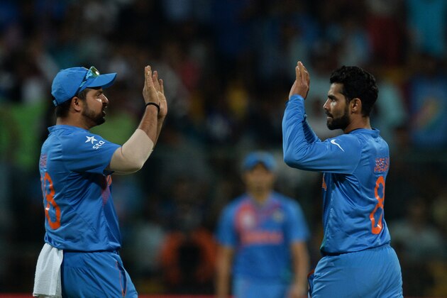 Indian bowler Ravindra Jadeja(R)celebrates with teammate Suresh Raina after his  dismissal of Bangladesh batsman Mashrafe Bin Mortaza during the World T20 cricket tournament match between India and Bangladesh at The Chinnaswamy Stadium in Bangalore on March 23, 2016.
 Bangladesh is chasing a target of 146 runs scored by India with a loss of 7 wickets. / AFP / MANJUNATH KIRAN        (Photo credit should read MANJUNATH KIRAN/AFP/Getty Images)