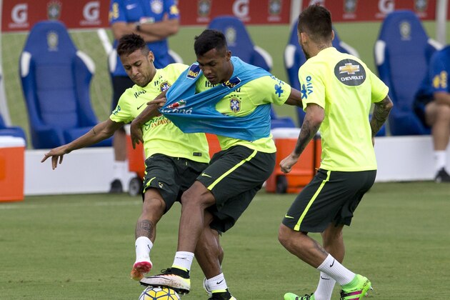 Brazil's Neymar, left, fights for the ball with Alex Sandro, center, during a Brazil national soccer team training session in Teresopolis, Brazil, Tuesday, March 22, 2016. Brazil will face Uruguay on a World Cup qualifying soccer match in Recife on March 25. (AP Photo/Silvia Izquierdo)