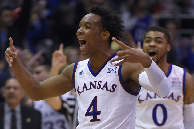 LAWRENCE, KS - FEBRUARY 9:  Devonte' Graham #4 of the Kansas Jayhawks celebrates a shot against the West Virginia Mountaineers in the first half at Allen Fieldhouse on February 9, 2015 in Lawrence, Kansas. (Photo by Ed Zurga/Getty Images)