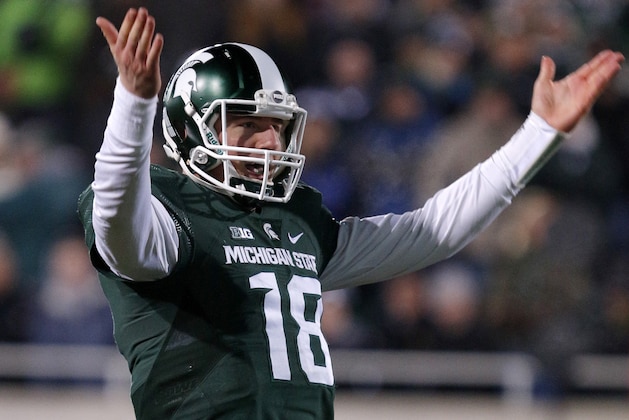 Michigan State quarterback Connor Cook encourages the crowd during the fourth quarter of an NCAA college football game against Penn State, Saturday, Nov. 28, 2015, in East Lansing, Mich. Michigan State won 55-16. (AP Photo/Al Goldis)