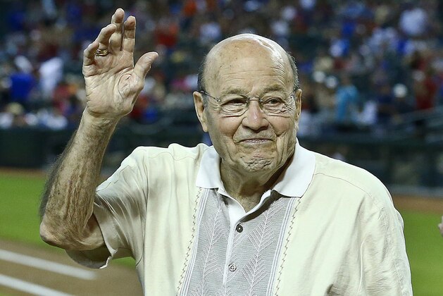 FILE - In this April 14, 2013, file photo, Arizona Diamondbacks broadcaster Joe Garagiola, center, waves to a cheering crowd during festivities honoring the retiring broadcaster, prior to a baseball game against the Los Angeles Dodgers, in Phoenix. Former big league catcher and popular broadcaster Joe Garagiola has died. He was 90. The Arizona Diamondbacks say Garagiola died Wednesday, March 23, 2016. He had been in ill health in recent years. (AP Photo/Ross D. Franklin, File)