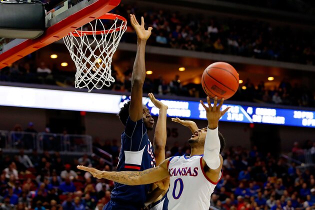 DES MOINES, IA - MARCH 19:  Frank Mason III #0 of the Kansas Jayhawks goes up against Amida Brimah #35 of the Connecticut Huskies during the second round of the 2016 NCAA Men's Basketball Tournament at Wells Fargo Arena on March 19, 2016 in Des Moines, Iowa.  (Photo by Kevin C. Cox/Getty Images)