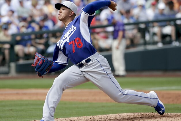 Los Angeles Dodgers starting pitcher Julio Urias throws during a spring training baseball exhibition game against the Chicago Cubs in Mesa, Ariz., on Wednesday, March 11, 2015. (AP Photo/Chris Carlson)
