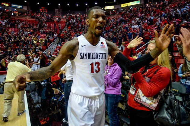 SAN DIEGO, CA - FEBRUARY 06:  Winston Shepard #13 of the San Diego State Aztecs celebrates their overtime win by high-fiving fansafter the game against the New Mexico Lobos at Viejas Arena on February 6, 2016 in San Diego, California.  (Photo by Kent Horner/Getty Images)