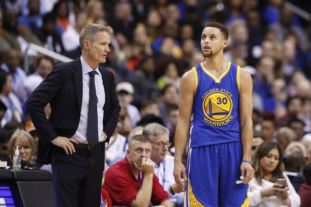 Golden State Warriors head coach Steve Kerr and Golden State Warriors guard Stephen Curry (30) talk in the second half of an NBA basketball game Washington Wizards, Wednesday, Feb. 3, 2016, in Washington. The Warriors won 134-121. (AP Photo/Alex Brandon)