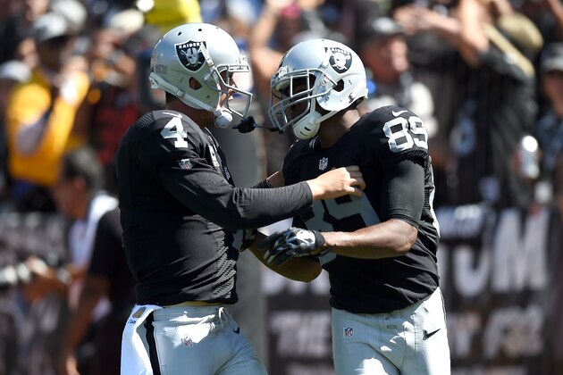 OAKLAND, CA - SEPTEMBER 20:  Derek Carr #4 of the Oakland Raiders celebrates a touchdown with Amari Cooper #89 of the Oakland Raiders in the first quarter against the Baltimore Ravens at Oakland-Alameda County Coliseum on September 20, 2015 in Oakland, California.  (Photo by Thearon W. Henderson/Getty Images)