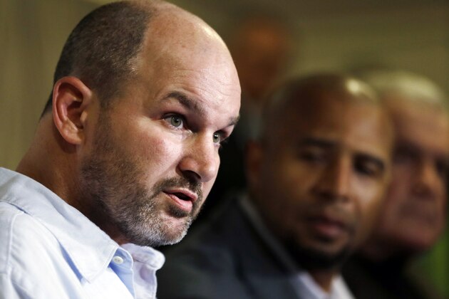FILE - In this April 9, 2013 file photo, former NFL player Kevin Turner, left,  speaks during a news conference in Philadelphia, as former players Dorsey Levens, center, and Bill Bergey listen. The NFL agreed Wednesday, June 25, 2014, to remove a $675 million cap on damages from thousands of concussion-related claims after a federal judge questioned whether there would be enough money to cover as many as 20,000 retired players. The plaintiffs include Kevin Turner, who played for the Philadelphia Eagles and New England Patriots and is now battling ALS. (AP Photo/Matt Rourke, File)