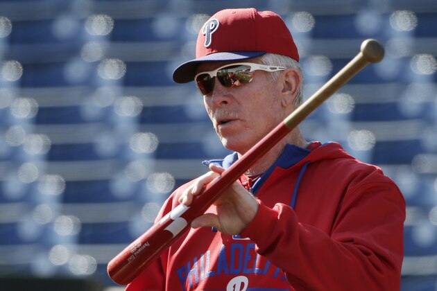 Philadelphia Phillies guest instructor Mike Schmidt, a Hall of Famer, uses a ball and a bat to demonstrate a principle of hitting during batting before a spring training baseball game against the Detroit Tigers in Clearwater, Fla., Sunday, March 29, 2015. (AP Photo/Kathy Willens)