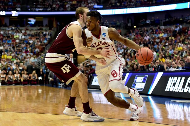 ANAHEIM, CA - MARCH 24:  Buddy Hield #24 of the Oklahoma Sooners drives on Alex Caruso #21 of the Texas A&M Aggies in the second half in the 2016 NCAA Men's Basketball Tournament West Regional at the Honda Center on March 24, 2016 in Anaheim, California.  (Photo by Harry How/Getty Images)