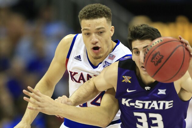 Kansas guard Brannen Greene (14) and Kansas State guard Brian Rohleder (33) chase down a loose ball during the second half of an NCAA college basketball game in the quarterfinals of the Big 12 conference tournament in Kansas City, Mo., Thursday, March 10, 2016. Kansas defeated Kansas State 85-63. (AP Photo/Orlin Wagner)