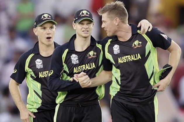 Australia's captain Steven Smith, centre, and Adam Zampa, left, congratulate bowler James Faulkner, right, after he took five wickets in their 21 run win over Pakistan in their ICC World Twenty20 2016 cricket match in Mohali, India, Friday, March 25, 2016. (AP Photo/Altaf Qadri)