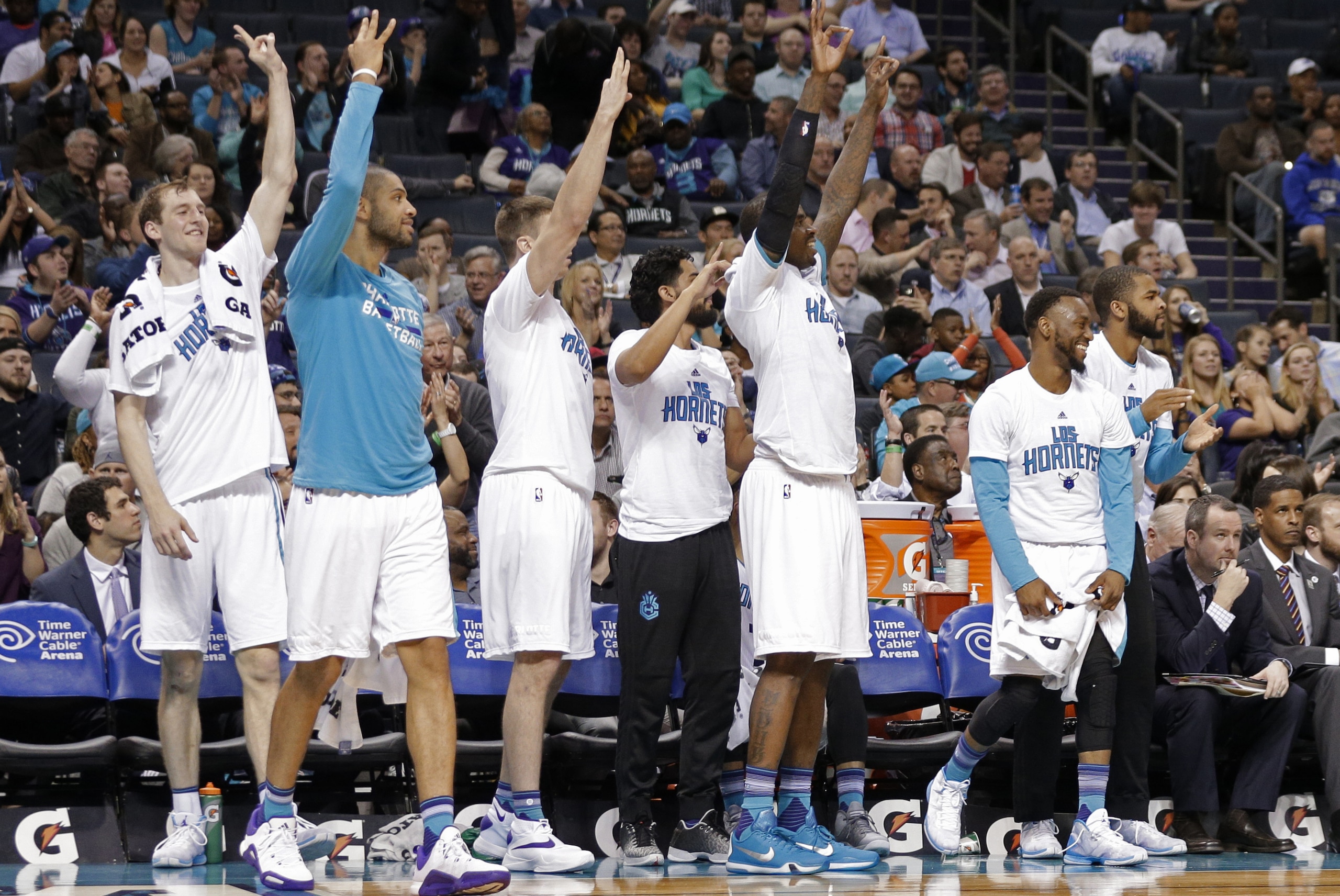 Charlotte Hornets players celebrate a teammate's 3-point basket against the Phoenix Suns in the second half of an NBA basketball game in Charlotte, N.C., Tuesday, March 1, 2016. The Hornets won 126-92. (AP Photo/Chuck Burton)