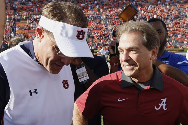 Alabama head coach Nick Saban, right, and Auburn head coach Gus Malzahn meet before a NCAA college football game, Saturday, Nov. 28, 2015, in Auburn, Ala. (AP Photo/Butch Dill)
