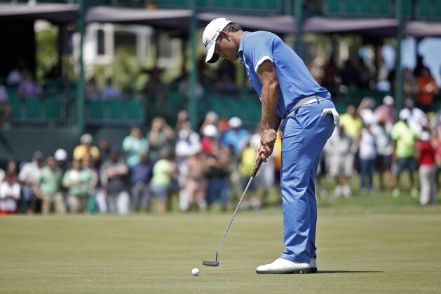 Puerto Rico’s Rafael Campos putts in the 18th hole green during the final round of the Puerto Rico Open PGA golf tournament in Rio Grande, Puerto Rico, Sunday, March 9, 2014. (AP Photo/Ricardo Arduengo)