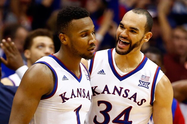 LAWRENCE, KS - JANUARY 04:  Wayne Selden Jr. #1 of the Kansas Jayhawks is congratulated by Perry Ellis #34  after making a three-pointer and drawing a foul during the second overtime of the game against the Oklahoma Sooners game at Allen Fieldhouse on January 4, 2016 in Lawrence, Kansas.  The Jayhawks defeated the Sooners in triple overtime with a final score of 109-106 to win the game.  (Photo by Jamie Squire/Getty Images)
