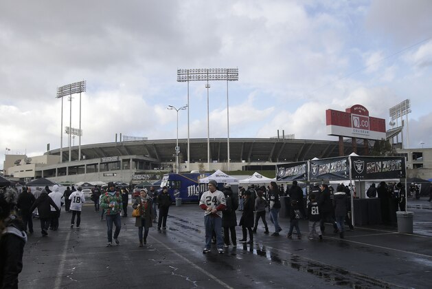 Fans tailgate at O.co Coliseum before an NFL football game between the Oakland Raiders and the San Diego Chargers in Oakland, Calif., Thursday, Dec. 24, 2015. (AP Photo/Marcio Jose Sanchez)