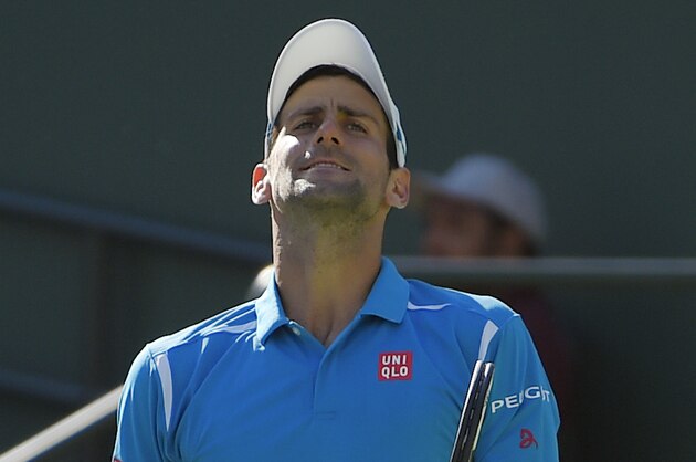 Novak Djokovic, of Serbia, reacts while playing Jo-Wilfried Tsonga, of France, during their quarterfinal match at the BNP Paribas Open tennis tournament, Friday, March 18, 2016, in Indian Wells, Calif. (AP Photo/Mark J. Terrill)