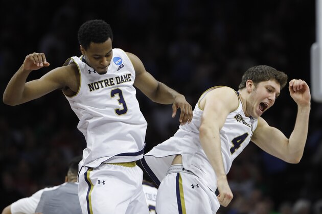 Notre Dame's V.J. Beachem, left, and Matt Ryan celebrate during an NCAA college basketball game against Wisconsin in the regional semifinals of the men's NCAA Tournament, Friday, March 25, 2016, in Philadelphia. Notre Dame won 61-56. (AP Photo/Matt Rourke)