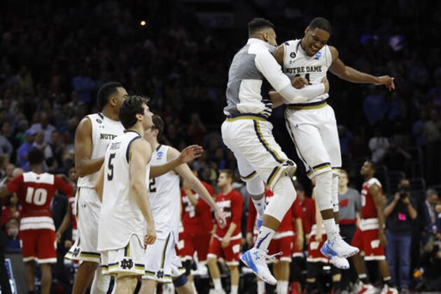 Notre Dame's Demetrius Jackson, right, celebrates with teammates after a steal from Wisconsin n the final seconds of an NCAA college basketball game in the regional semifinals of the men's NCAA Tournament, Friday, March 25, 2016, in Philadelphia. Notre Dame won 61-56. (AP Photo/Chris Szagola)