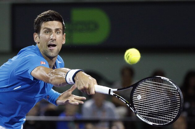 Novak Djokovic of Serbia, attempts to return a shot from Kyle Edmund of Britain, during a match at the Miami Open tennis tournament, in Key Biscayne, Fla., Friday, March 25, 2016. Djokovic defeated Edmund 6-3, 6-3. (AP Photo/Wilfredo Lee)